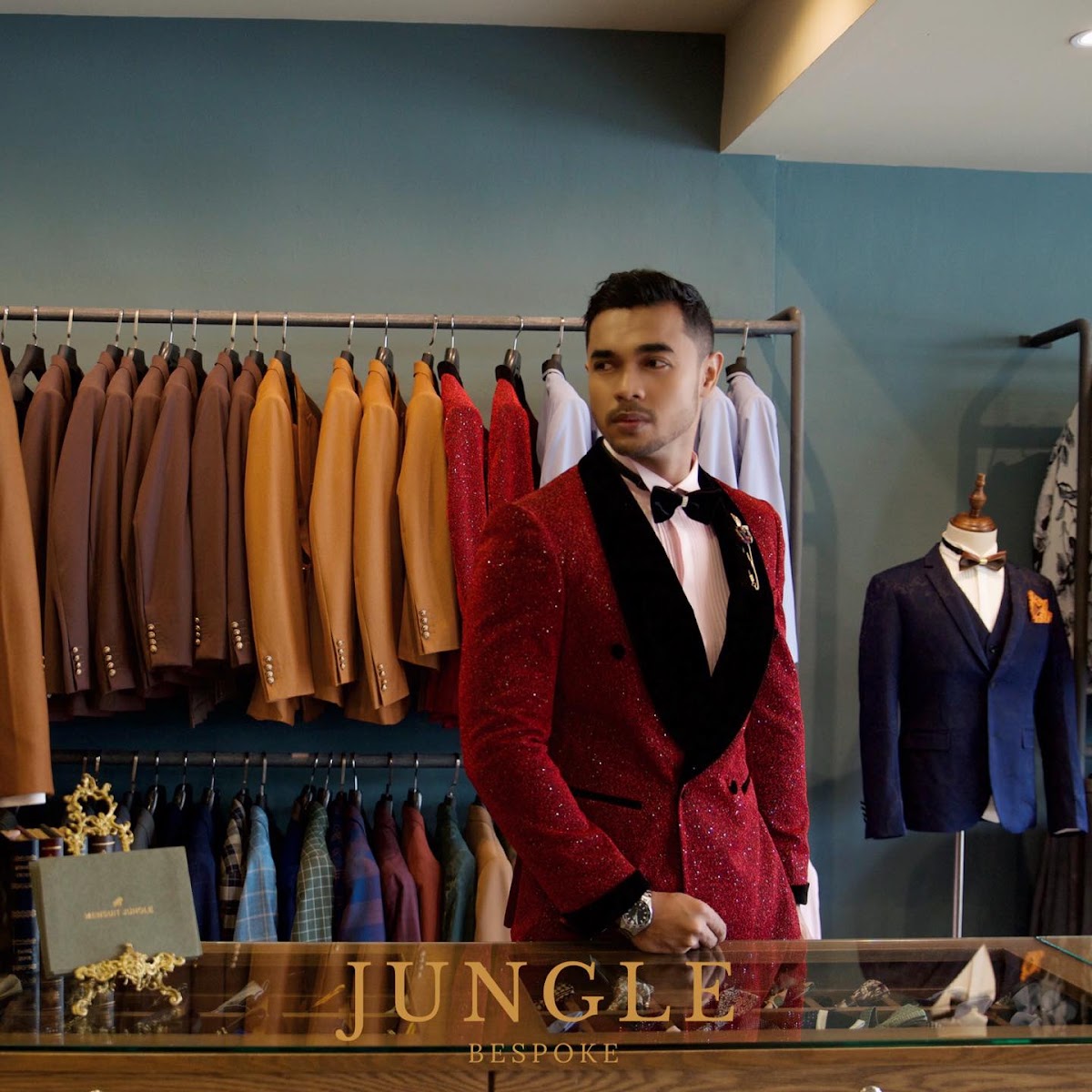 A customer in a custom red tuxedo at JUNGLE Bespoke